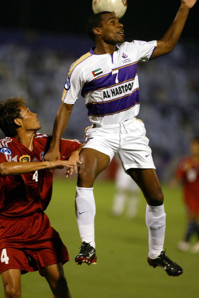 Emirati player Mohammad Omar Mohammad (R) of Emirati Al Ain club, jumps for the ball with Thai defender Witthaya Nubthong (L) of Thai Tero Sasana club during their AFC Champions League final in al-Ain 03 October 2003. AFP PHOTO/Rabih MOGHRABI (Photo by RABIH MOGHRABI / AFP)