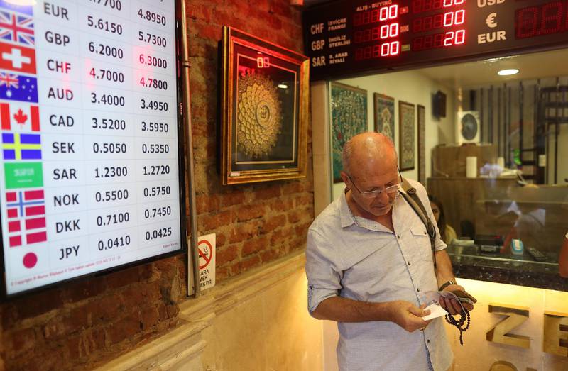 epa06907916 People exchange money at a currency exchange office in Istanbul, Turkey, 24 July 2018. Reports on 24 July state Turkish Lira  hit new lows against major currencies, recording 4.93 liras against the US dollar and 5.78 liras against the Euro. Turkish Lira has continued to lose in value against major currencies, partly accelerated by Turkey's annual inflation hitting 15.4 per cent in June 2018.  EPA/ERDEM SAHIN