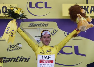 UAE Team Emirates' Adam Yates celebrates on the podium after winning Stage 1 of the Tour de France,  on July 1, 2023. Reuters
