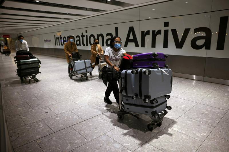 Travellers walk through the arrivals area at Heathrow Airport. Reuters