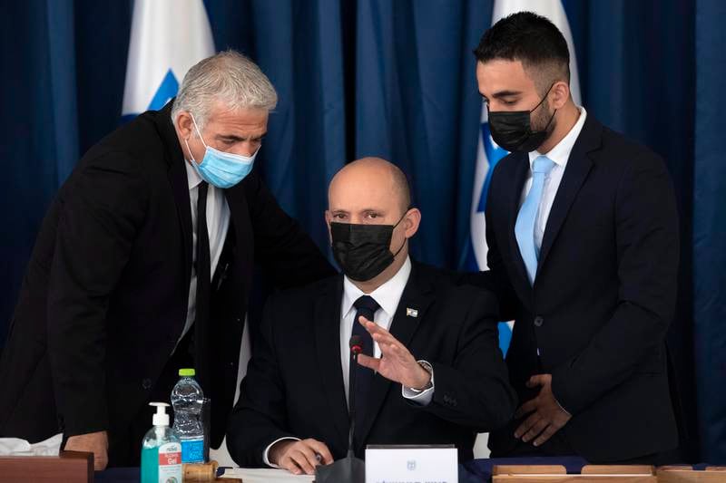 Israeli Prime Minister Naftali Bennett, centre, and Israeli Minister of Foreign Affairs Yair Lapid, left, at a weekly Cabinet meeting in Jerusalem. EPA