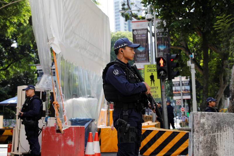 Police stand guards outside St Regis hotel in Singapore. Tyrone Siu / Reuters