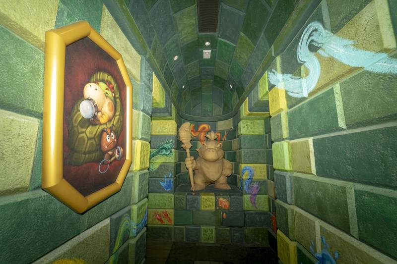 Images of Baby Bowser line this hallway at Super Nintendo World theme park. Bloomberg