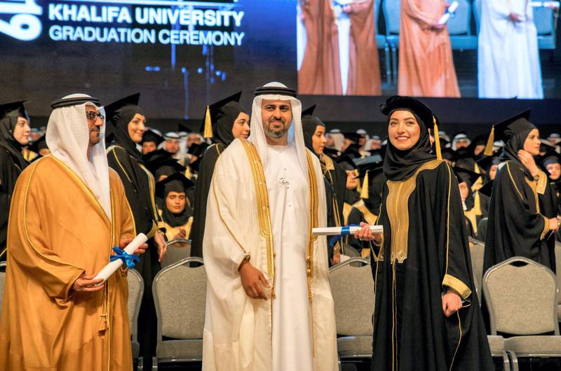 ABU DHABI, UNITED ARAB EMIRATES - October 20, 2019: HH Sheikh Theyab bin Mohamed bin Zayed Al Nahyan, Abu Dhabi Executive Council member and Chairman of the abu Dhabi Crown Prince Court (CPC) (C), presents a certificate to a graduating student during the Khalifa University Graduation Ceremony, at Emirates Palace. Seen with HE Hussain Ibrahim Al Hammadi, UAE Minister of Education (L).( Hamad Al Kaabi / Ministry of Presidential Affairs )​---