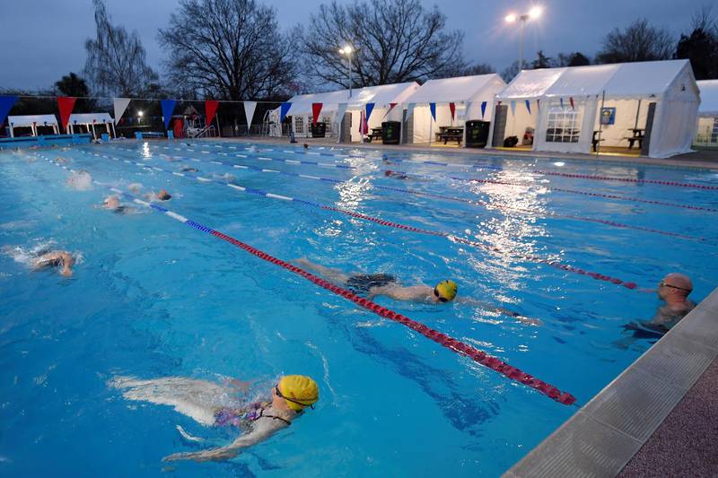 Swimmers train in Hampton Lido in London on the first day that outdoor pools are allowed to open. Reuters