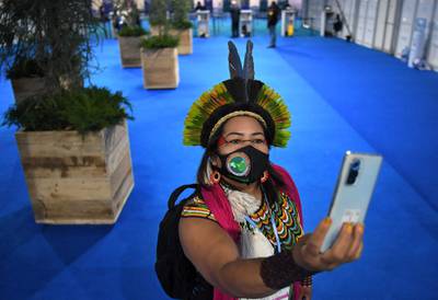 Simone Karipuna, from the Amazonian Brazilian indigenous community, takes a selfie photograph at the summit. AFP