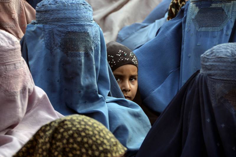 Women in Kandahar, Afghanistan, wait to receive iftar meals donated by Our Afterlife Foundation. AFP