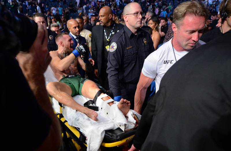 Conor McGregor is carried off on a stretcher following an injury suffered against Dustin Poirier during UFC 264 at T-Mobile Arena in Las Vegas.