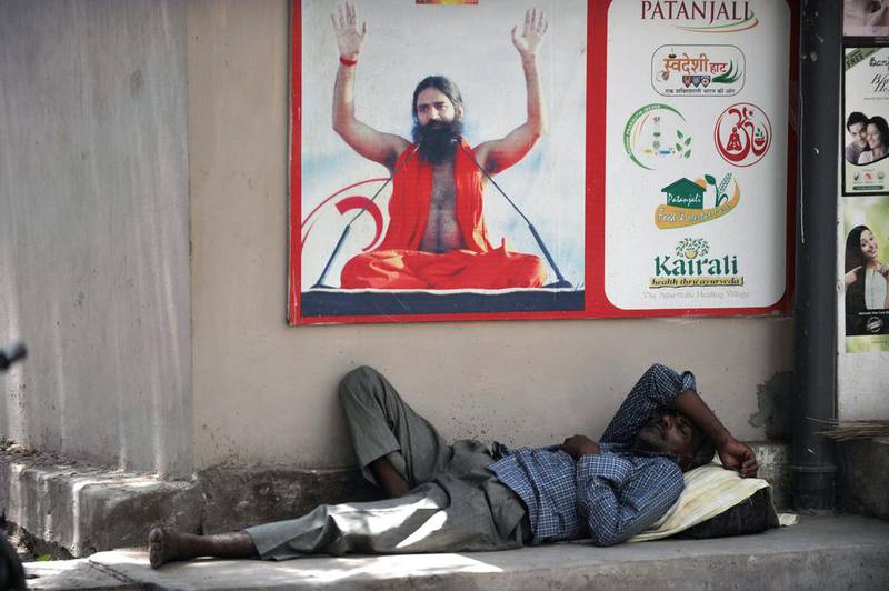 A man rests in the shade on a sweltering day in Hyderabad.  Noah Seelam / AFP