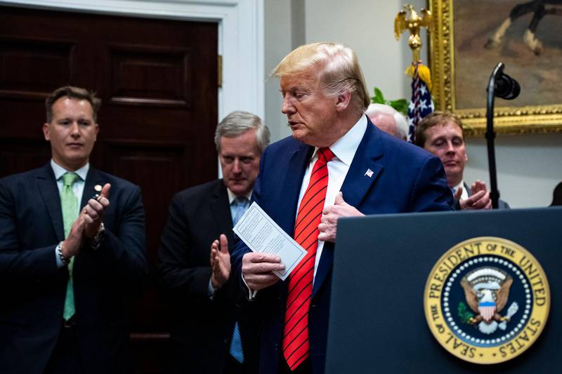 In this Wednesday, Oct. 9, 2019 photo, President Donald Trump finishes speaking after a signing ceremony for Executive Orders on transparency in federal guidance and enforcement in the Roosevelt Room at the White House in Washington (Jabin Botsford/The Washington Post via AP)