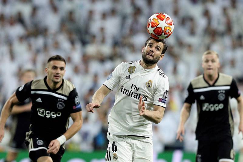 Real Madrid's Nacho Fernandez, centre,  in action during the UEFA Champions League round of 16 second leg match against Ajax at the Bernabeu. EPA
