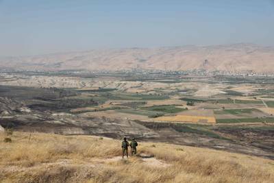 In this file photo taken on June 23, 2019 Israeli soldiers stand guard in an old army outpost overlooking the Jordan Valley. AFP