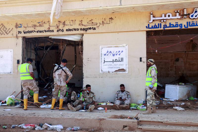 LNA soldiers sent to help in the aftermath of the fatal flash floods in Derna take a breather. AFP