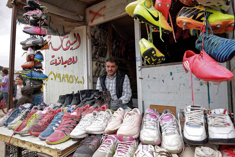 A market stallholder at the camp hopes for brisk business. AFP