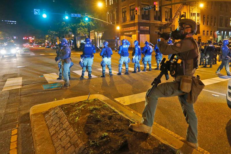 Police secure an intersection during a third night of unrest in Richmond, Virginia. AP Photo