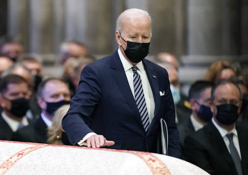 US President Joe Biden passes by the casket. AP