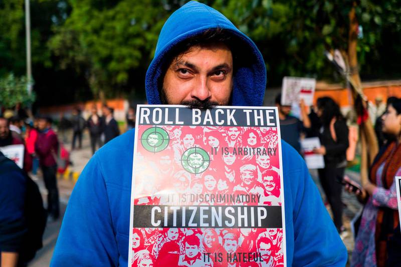 A protester displays a placard during a demonstration against the Indian government's Citizenship Amendment Bill in New Delhi. AFP