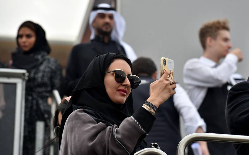 A Saudi woman takes photographs with her mobile phone. AFP