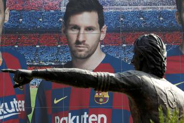 Soccer Football - Camp Nou, Barcelona, Spain - August 26, 2020 A statue of Johan Cruyff is seen infront of an image of Lionel Messi outside the Camp Nou after captain Lionel Messi told Barcelona he wishes to leave the club immediately, a source confirmed on Tuesday REUTERS/Nacho Doce