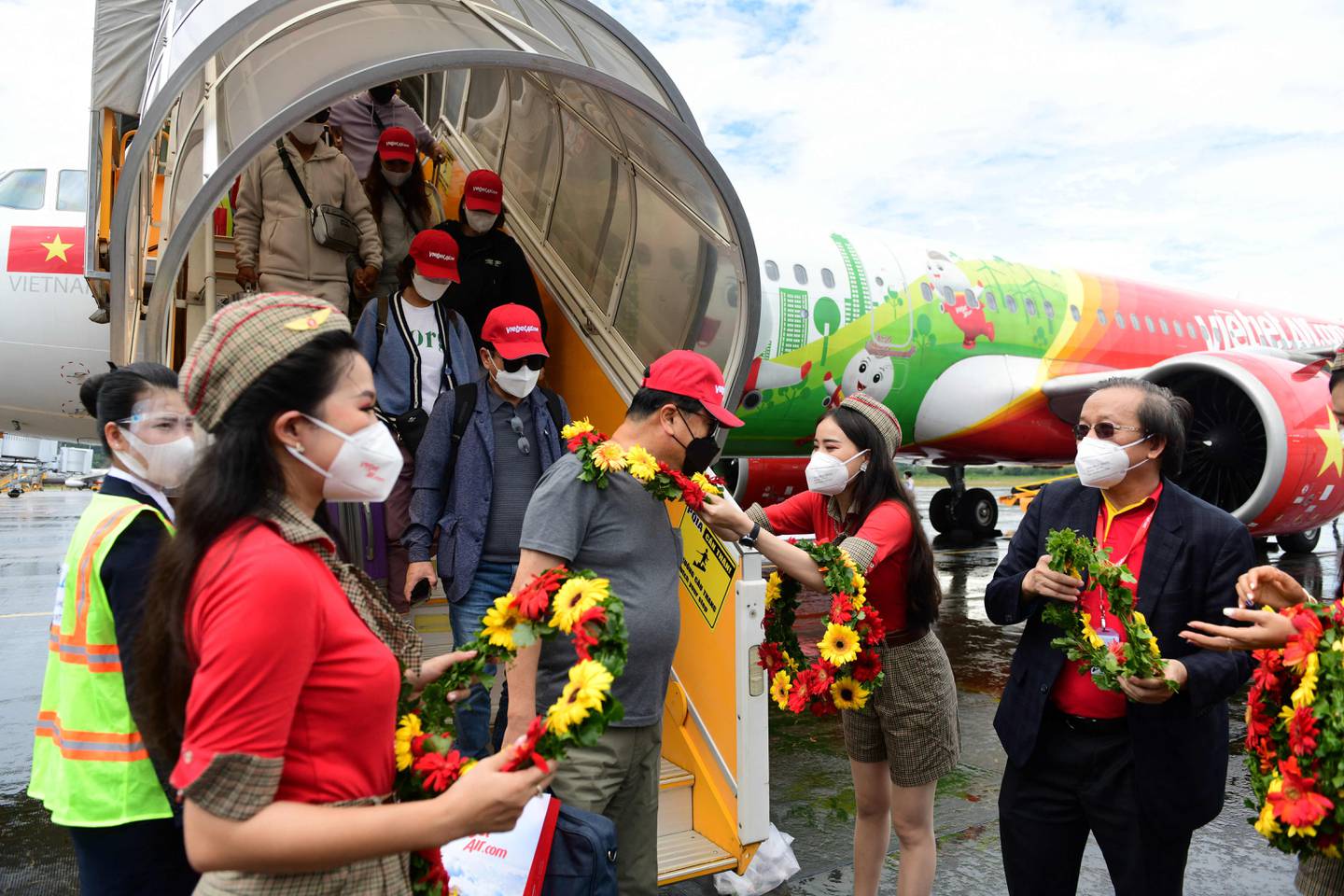 South Korean tourists arrive at Phu Quoc International Airport, as the Vietnamese island welcomed its first international tourists following a Covid-19 vaccine passport scheme. AFP