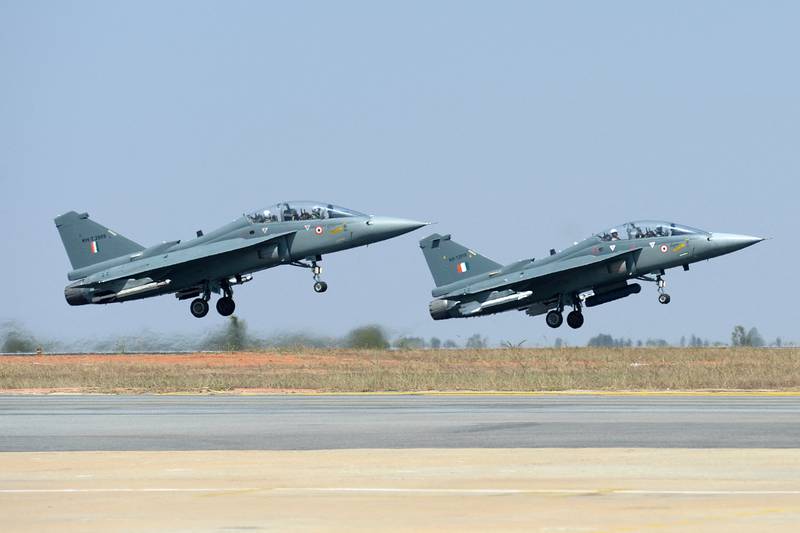 A pair of Tejas during a display on the second day of the Aero India exhibition at Yelahanka Air Force base in Bangalore.