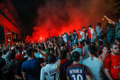 The Champs Elysee comes alive with PSG fans. AP