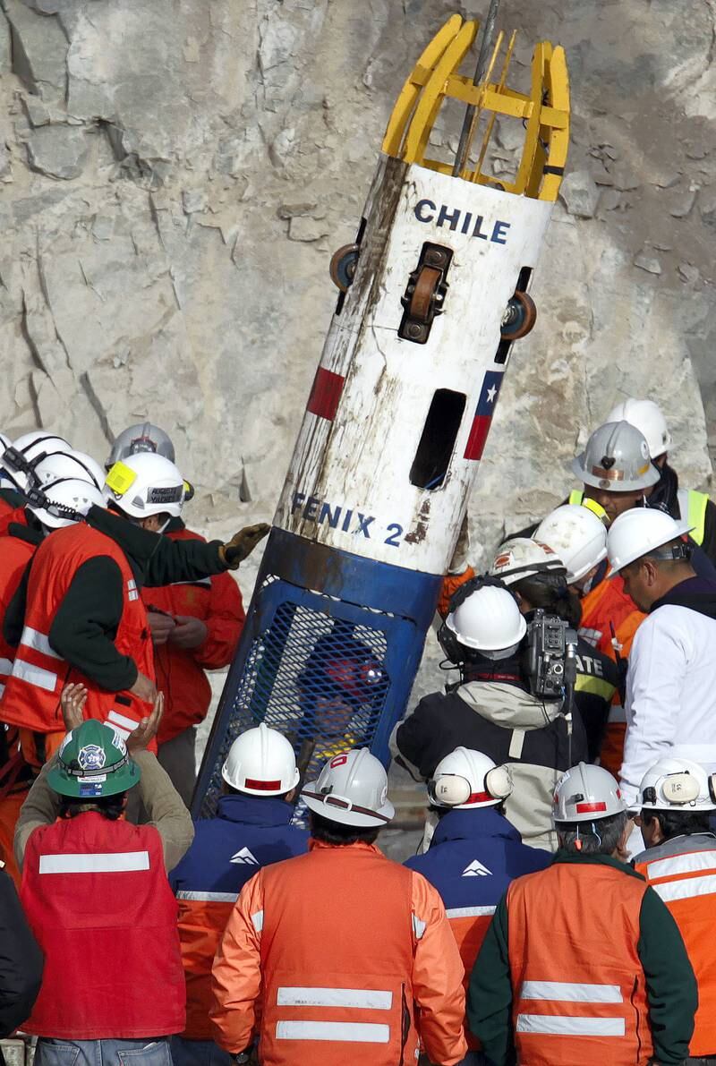 Miner Alex Vega arrives inside the capsule as the tenth to be rescued in Copiapo October 13, 2010. Chile's 33 trapped miners are set to travel nearly half a mile through solid rock in a shaft just wider than a man's shoulders on Tuesday night, as their two month ordeal after a cave-in draws to an end.       REUTERS/David Mercado (CHILE - Tags: DISASTER BUSINESS IMAGES OF THE DAY)