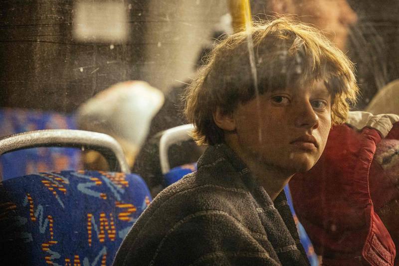 A boy looks out of a bus window as people evacuated from Mariupol arrive in Zaporizhzhia. AFP