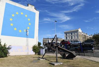epa06920756 A view of a Brexit-inspired mural by anonymous British street artist Banksy depicting the European flag in Dover, Britain, 31 July 2018. The graffiti that appeared on a building near Dover's ferry terminal shows a worker removing one of the 12 stars from the EU flag.  EPA-EFE/FACUNDO ARRIZABALAGA