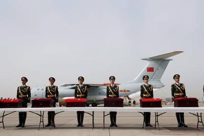 Members of a Chinese honour guard stand in front of boxes containing the remains of Chinese soldiers who were killed in the 1950-53 Korean War during a repatriation ceremony at Incheon Airport in South Korea. Jeon Heon-kyun / EPA