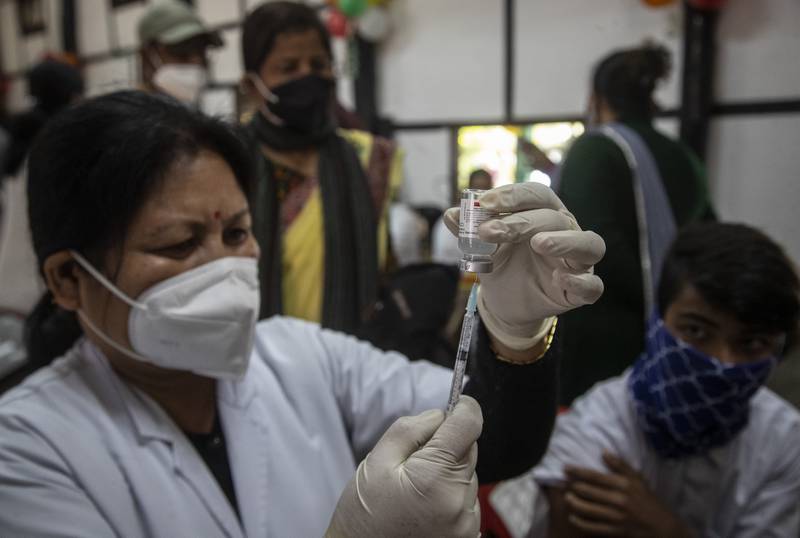 A health worker prepares to vaccinate a teenager in Gauhati, India. On Monday, state governments across the country administered doses at schools, hospitals and special vaccination sites amid a rapid rise in coronavirus infections. AP Photo