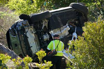 The vehicle rests on its side after the rollover accident involving golfer Tiger Woods. AP Photo