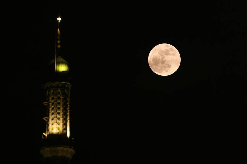 The blue moon appears beside a mosque in Chennai, India. AFP