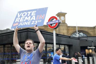 A "Vote Remain" activist urges people to vote outside Kings Cross station in central London on June 23, 2016, as Britain holds a referendum on whether to remain in, or to leave the European Union (EU). - Millions of Britons began voting Thursday in a bitterly-fought, knife-edge referendum that could tear up the island nation's EU membership and spark the greatest emergency of the bloc's 60-year history. (Photo by ODD ANDERSEN / AFP)