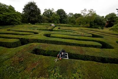 Gardener Gemma Hearn making a final trim of the Hampton Court Maze before it reopens to the public at Hampton Court Palace, in south-west London.