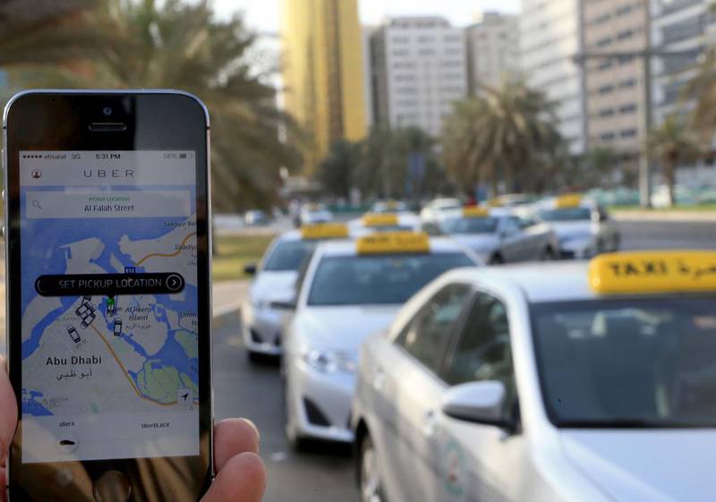 Book a taxi on a smart phone in Abu Dhabi. Antonie Robertson / The National