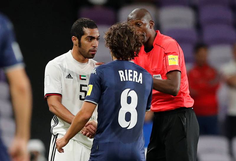 Al Jazira’s Musallem Fayez clashes with Auckland City’s Albert Riera as referee Malang Diedhiou looks on. Reuters
