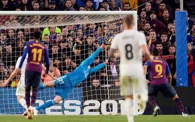 Barcelona's Uruguayan forward Luis Suarez (R) scores his second goal during the Spanish league football match between FC Barcelona and Real Madrid CF at the Camp Nou stadium in Barcelona. AFP
