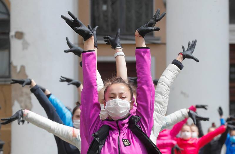 Young Ukrainian gymnasts wearing protective face masks and gloves seen during a training session in central Kiev.  EPA