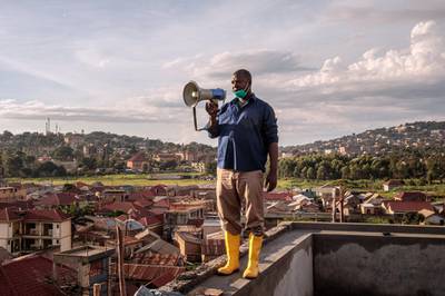 Gonzaga Yiga, a 49-year-old community chairperson, appeals to residents through a speaker from the tallest building of the area in morning and evening, on how to curb the COVID-19 coronavirus, in Kampala, Uganda, on March 24, 2020. (Photo by Badru KATUMBA / AFP)