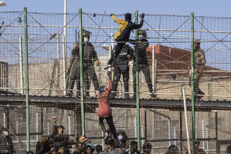 Migrants attempt to cross from Morocco into the Spanish enclave of Melilla on Friday. All photos: AP Photo