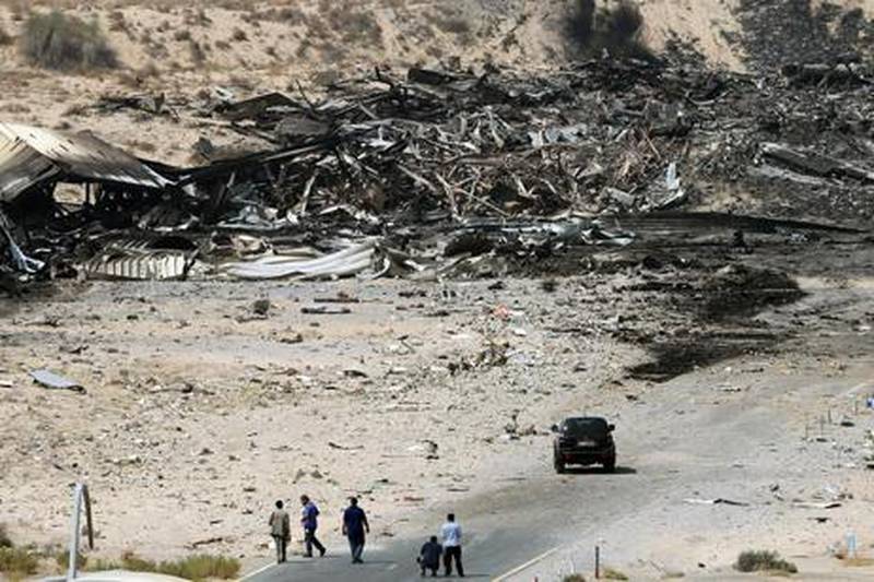 epa02315969 United Arab Emirates (UAE) officials are seen at the site where a cargo airplane crashed while taking off from Dubai airport, United Arab Emirates, on 04 September 2010. A United Parcel Services (UPS) cargo plane crashed near Dubai airport on 03 September 2010 as it was taking off for Germany. Officials in the Emirate said two people died in the incident.  EPA/ALI HAIDER