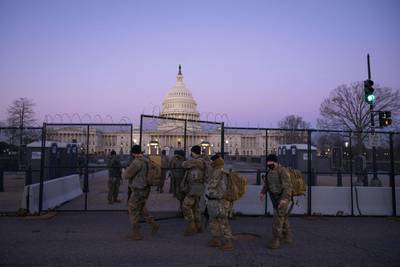 WASHINGTON, DC - FEBRUARY 08: Members of the National Guard enter a gate of barbed wire fencing on U.S. Capitol grounds at sunrise on February 8, 2021 in Washington, DC. The Senate is scheduled to begin the second impeachment trial of former U.S. President Donald J. Trump on February 9.   Sarah Silbiger/Getty Images/AFP
== FOR NEWSPAPERS, INTERNET, TELCOS & TELEVISION USE ONLY ==
