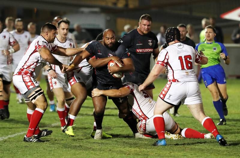 Abu Dhabi Harlequins players attempt to tackle a Dubai Exiles player during the UAE Premiership final. 