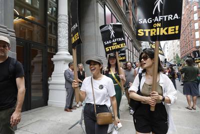 America Ferrera, left, joins the picket line outside Netflix and Warner Bros in New York City. Getty Images