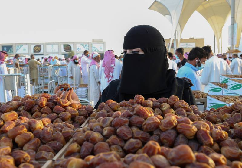 A Saudi woman peruses the vast selection of dates on display in Unaizah, Saudi Arabia, during the Unaizah Season for Dates.