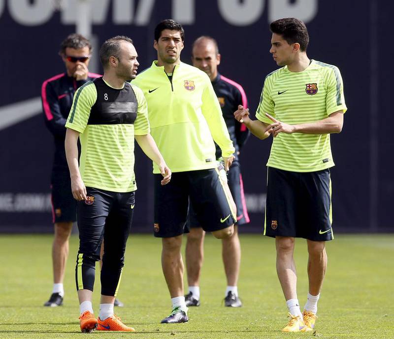 Barcelona's Andres Iniesta, Luis Suarez and Marc Bartra attend a training session on Monday for their Champions League match against PSG on Tuesday. Albert Gea / Reuters