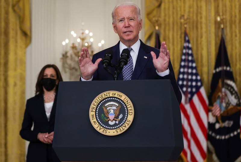 US President Joe Biden answers questions from reporters as Vice President Kamala Harris looks on in the East Room of the White House in Washington, on August 10, 2021.  Reuters