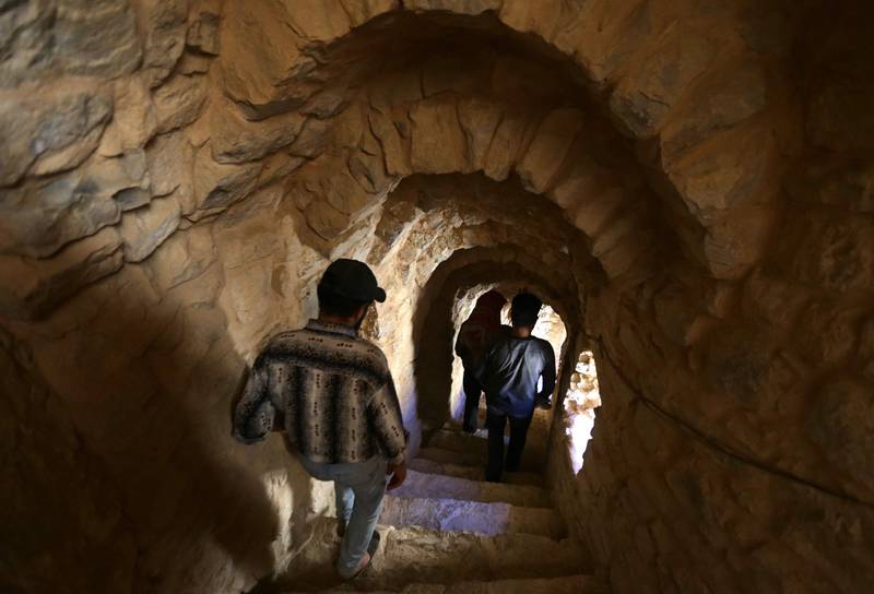 People walk down a stairway at Deir Mar Moussa Al Habashi.