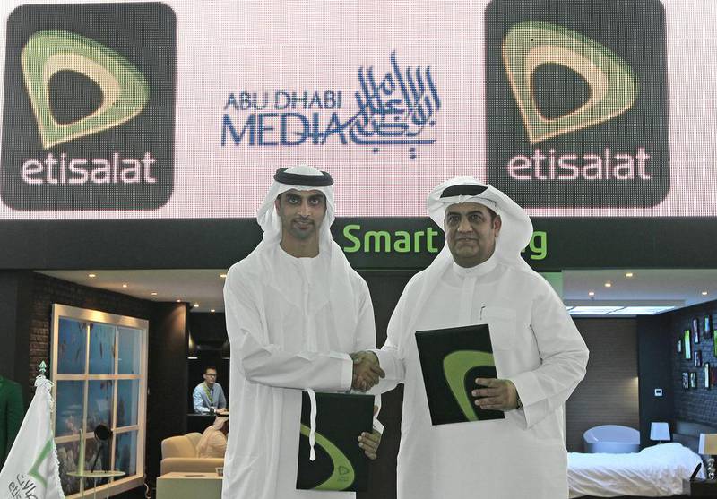 HE Mohamed Ebraheem Al Mahmood, the chairman of Abu Dhabi Media, left, and Saleh Al Abdooli, chief executive of Etisalat. Jeffrey E Biteng / The National